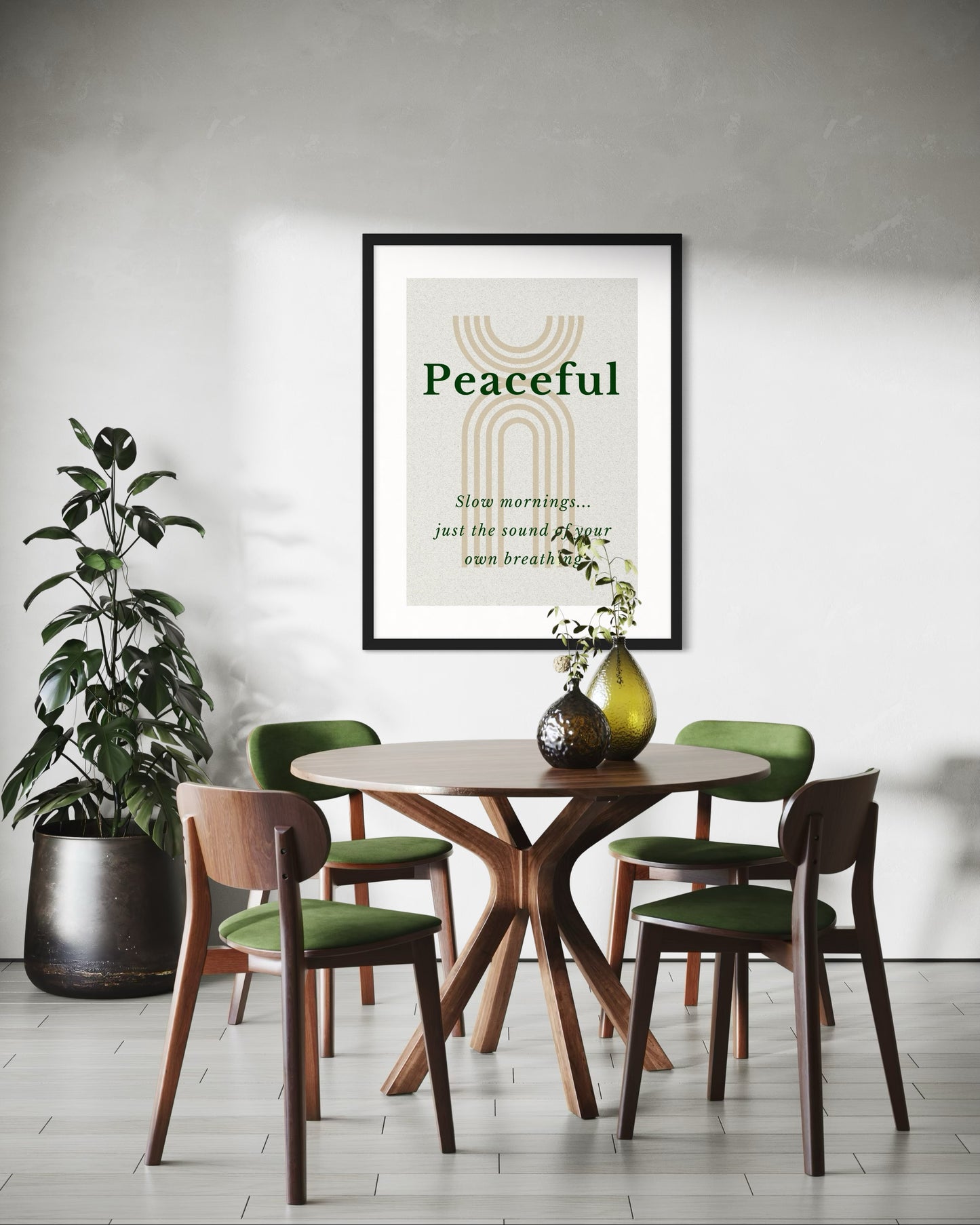 Dining room with a round table and chairs, a plant, and a framed poster on the wall.