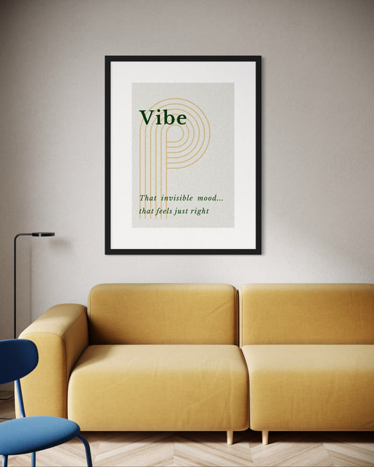 Framed poster with 'Vibe' text on a wall above a yellow sofa.