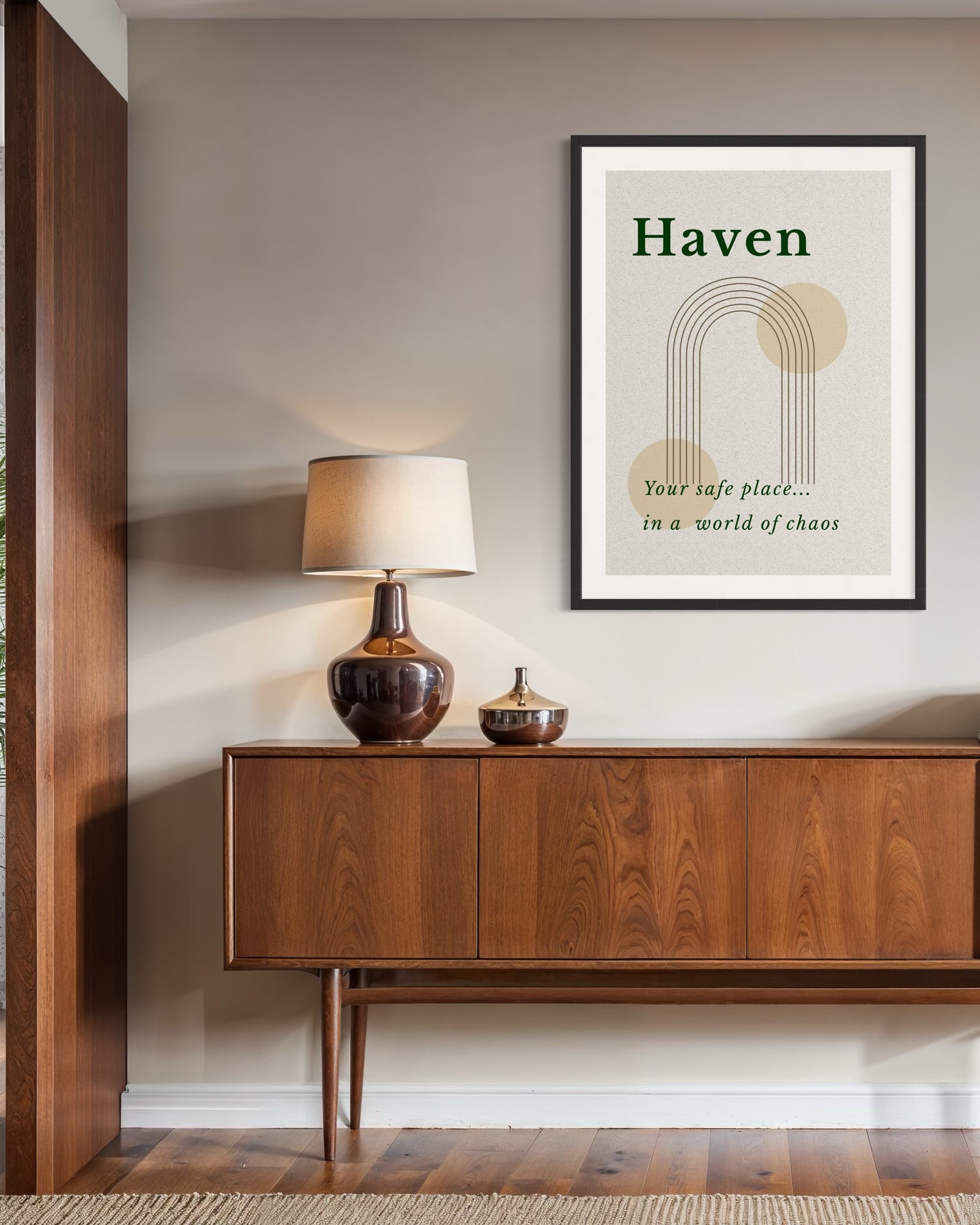 Wooden sideboard with a lamp and decorative items, framed artwork on the wall.