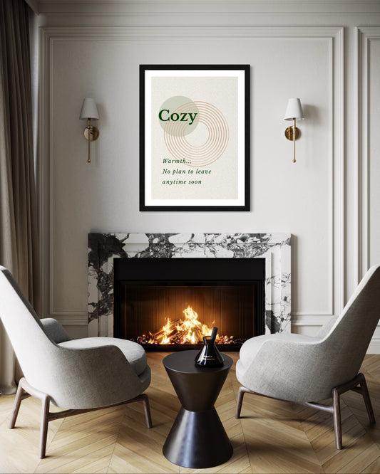 Cozy living room with fireplace, chairs, and a framed poster on the wall.