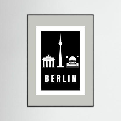 Framed poster with Berlin landmarks on a black background and a light grey border.