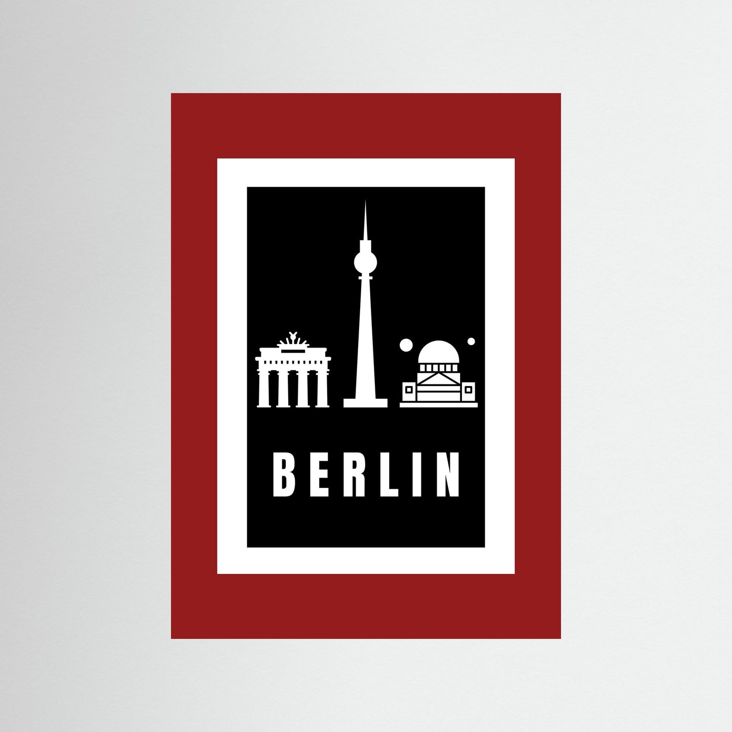 Unframed poster with Berlin landmarks and 'BERLIN' text on a black background and deep red border