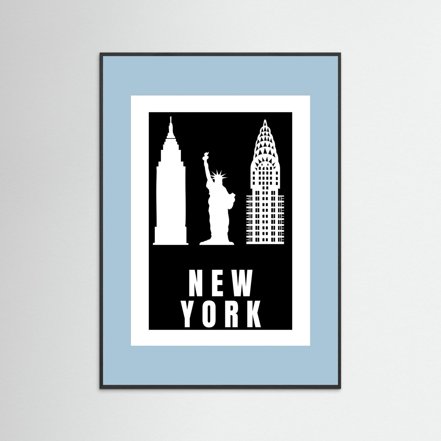 Framed artwork with New York City landmarks on a black background with a pale blue border.
