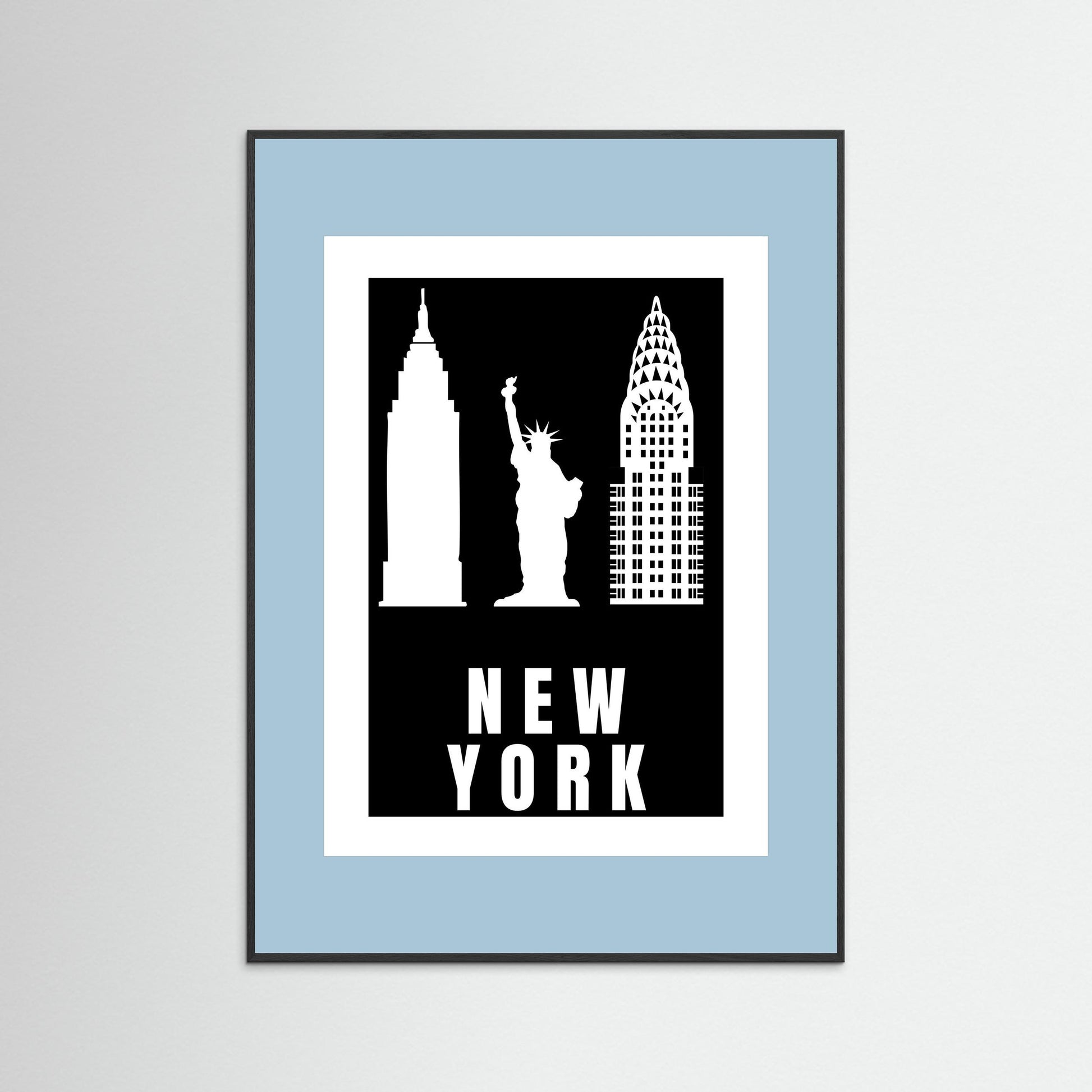 Framed artwork with New York City landmarks on a black background with a pale blue border.