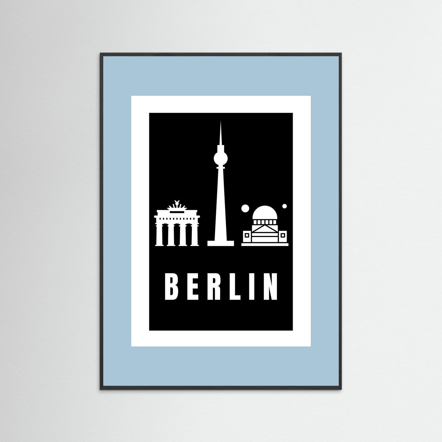 Framed poster with Berlin landmarks on a black background inside a light blue border.