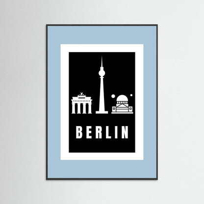 Framed poster with Berlin landmarks on a black background inside a light blue border.