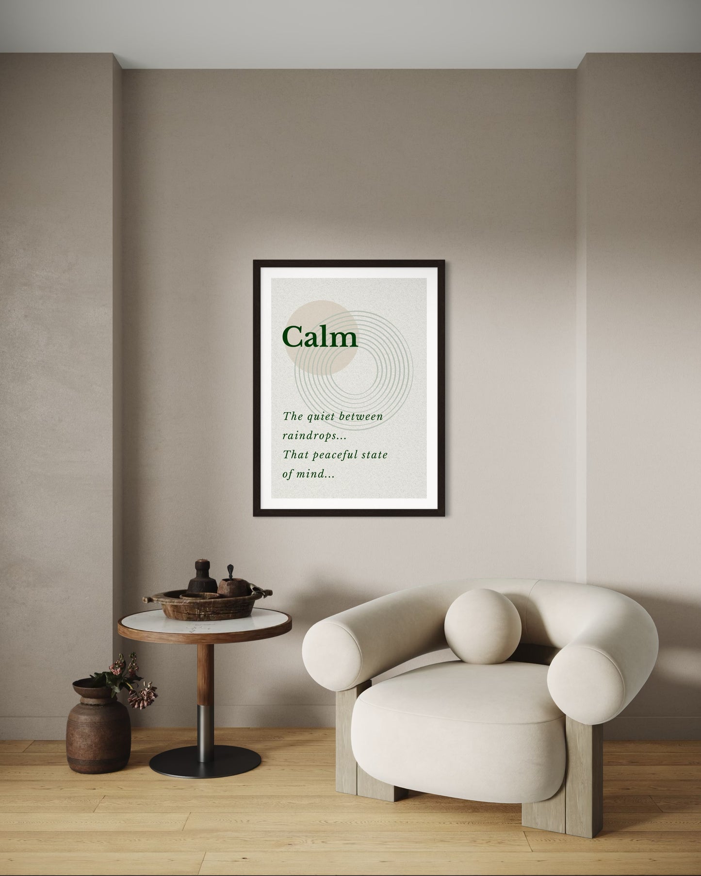 Framed poster with the word 'Calm' in a modern interior setting with a chair and small table.