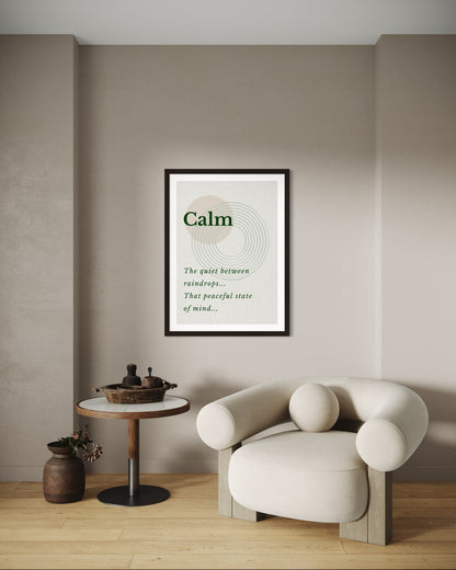 Framed poster with the word 'Calm' in a modern interior setting with a chair and small table.