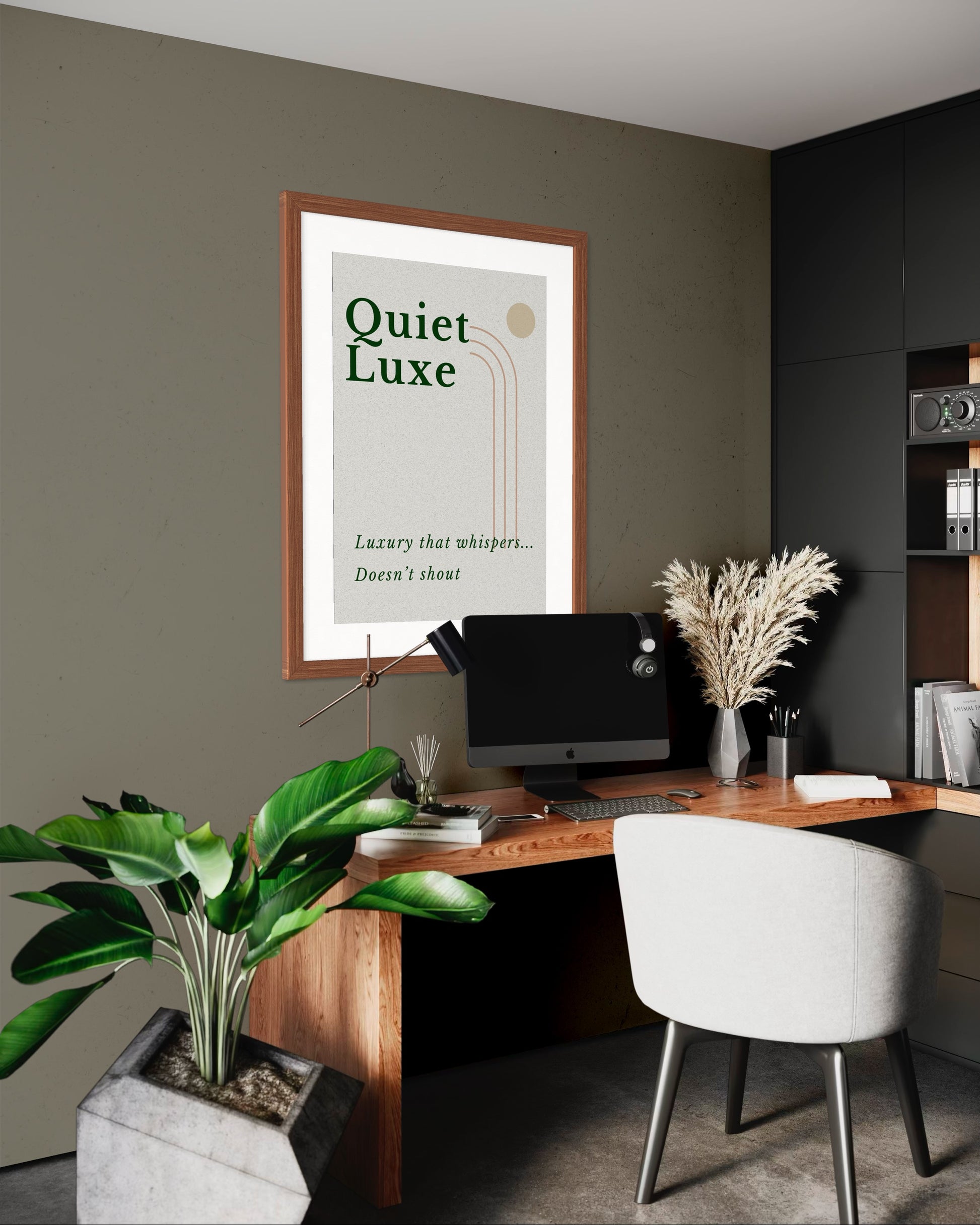 Modern office space with a desk, chair, and framed poster on the wall.