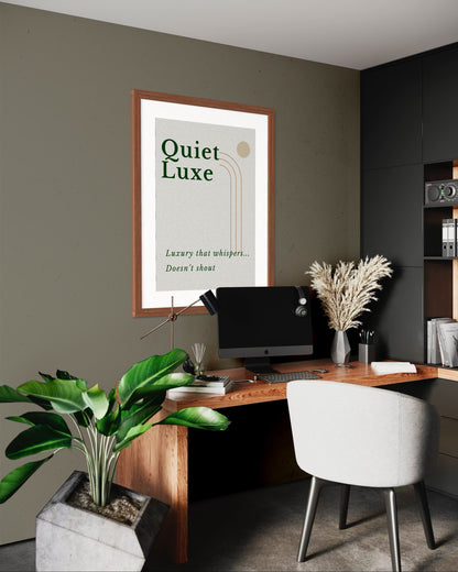 Modern office space with a desk, chair, and framed poster on the wall.