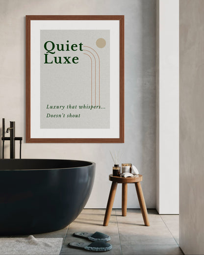 Framed artwork with 'Quiet Luxe' text in a modern bathroom setting.