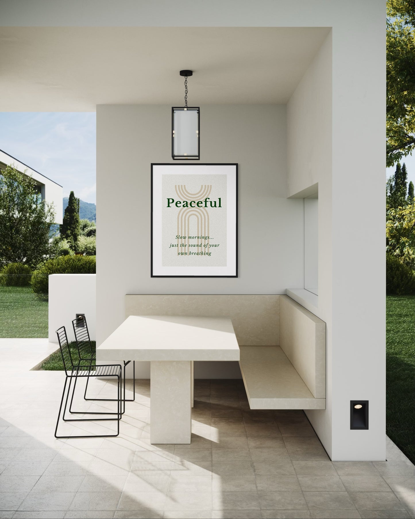 Modern outdoor seating area with a table and chairs, featuring a 'Peaceful' framed print on the wall.