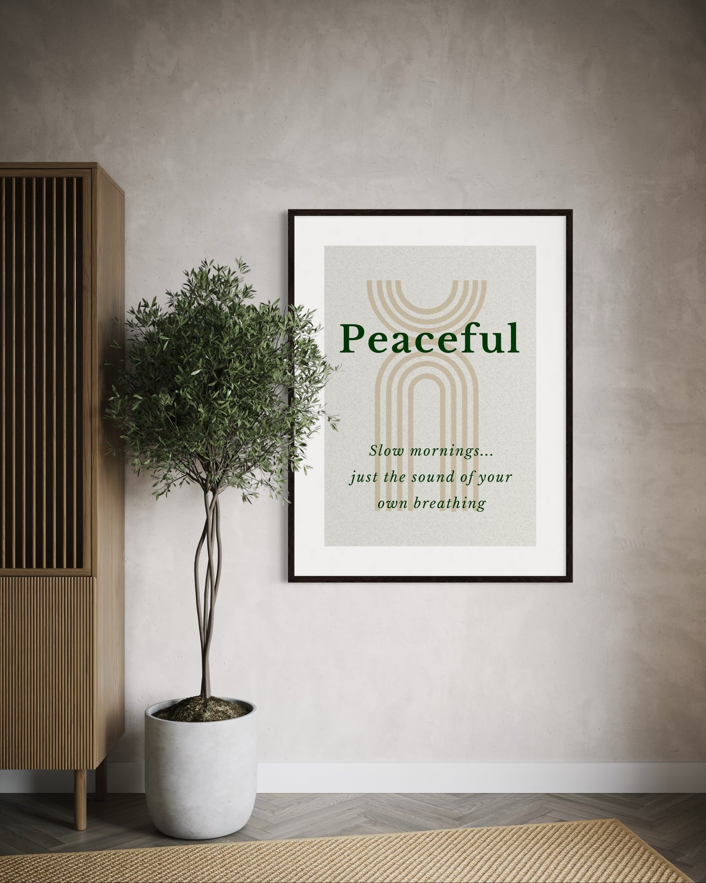Framed artwork with 'Peaceful' text in a room with a plant and wooden cabinet.