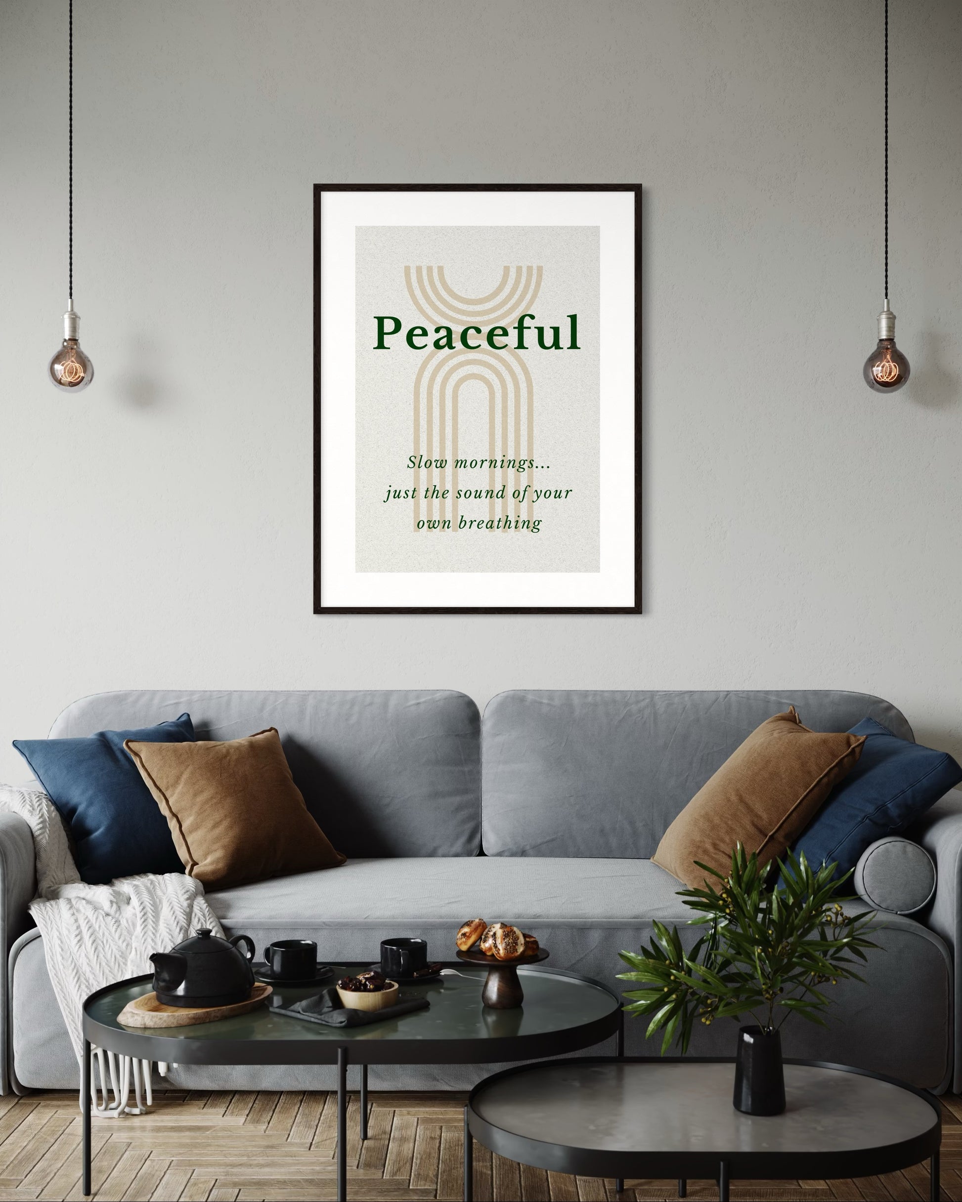 Living room with a gray sofa, coffee table, and framed artwork on the wall.