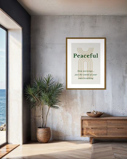 Framed artwork with 'Peaceful' text in a modern interior setting with a plant and wooden cabinet.