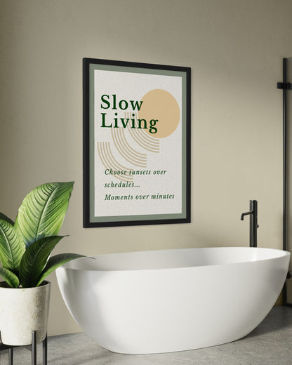 Framed 'Slow Living' poster above a modern white bathtub with a plant on a gray floor.