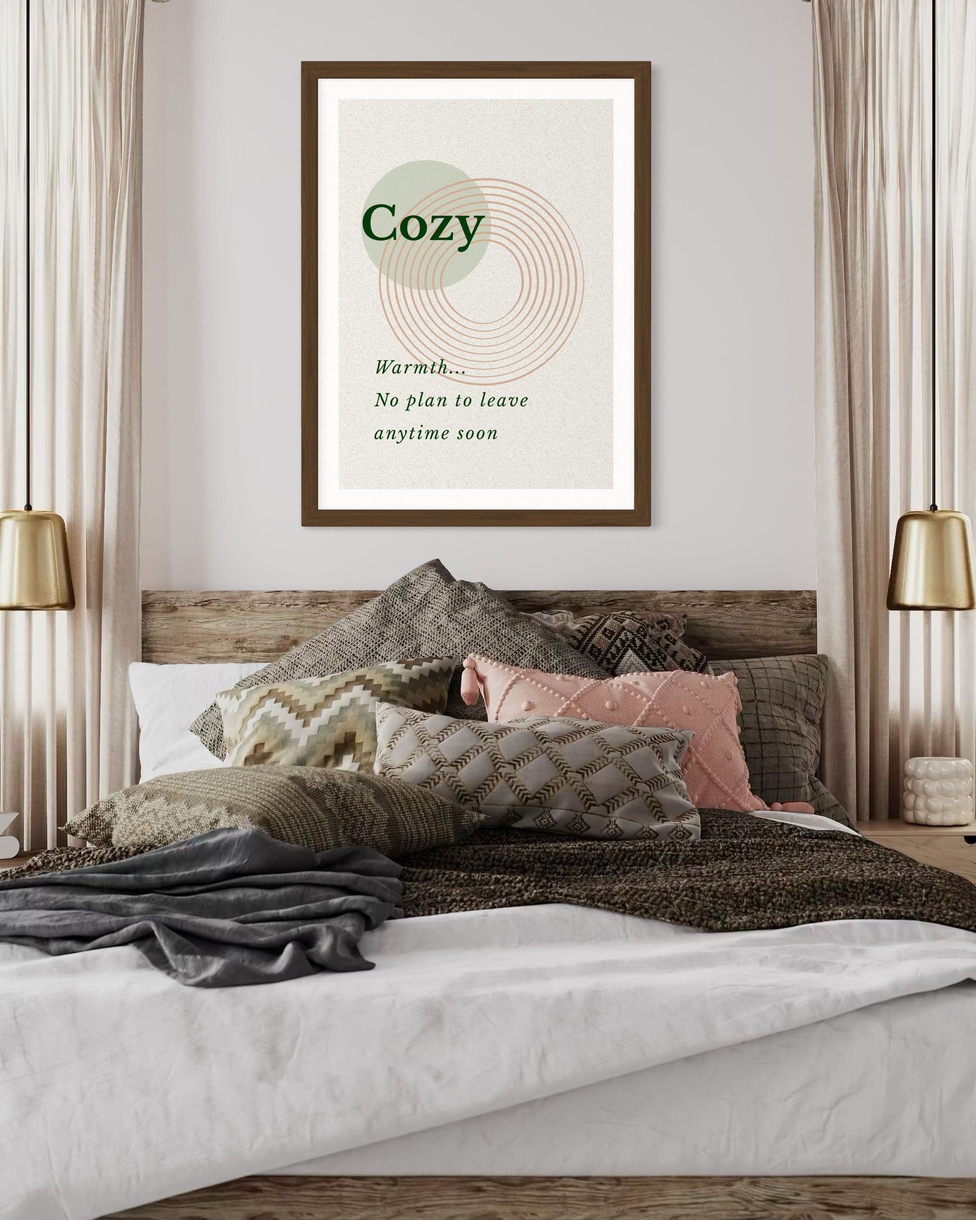 Framed artwork with 'Cozy' text above a bed with pillows and blankets.