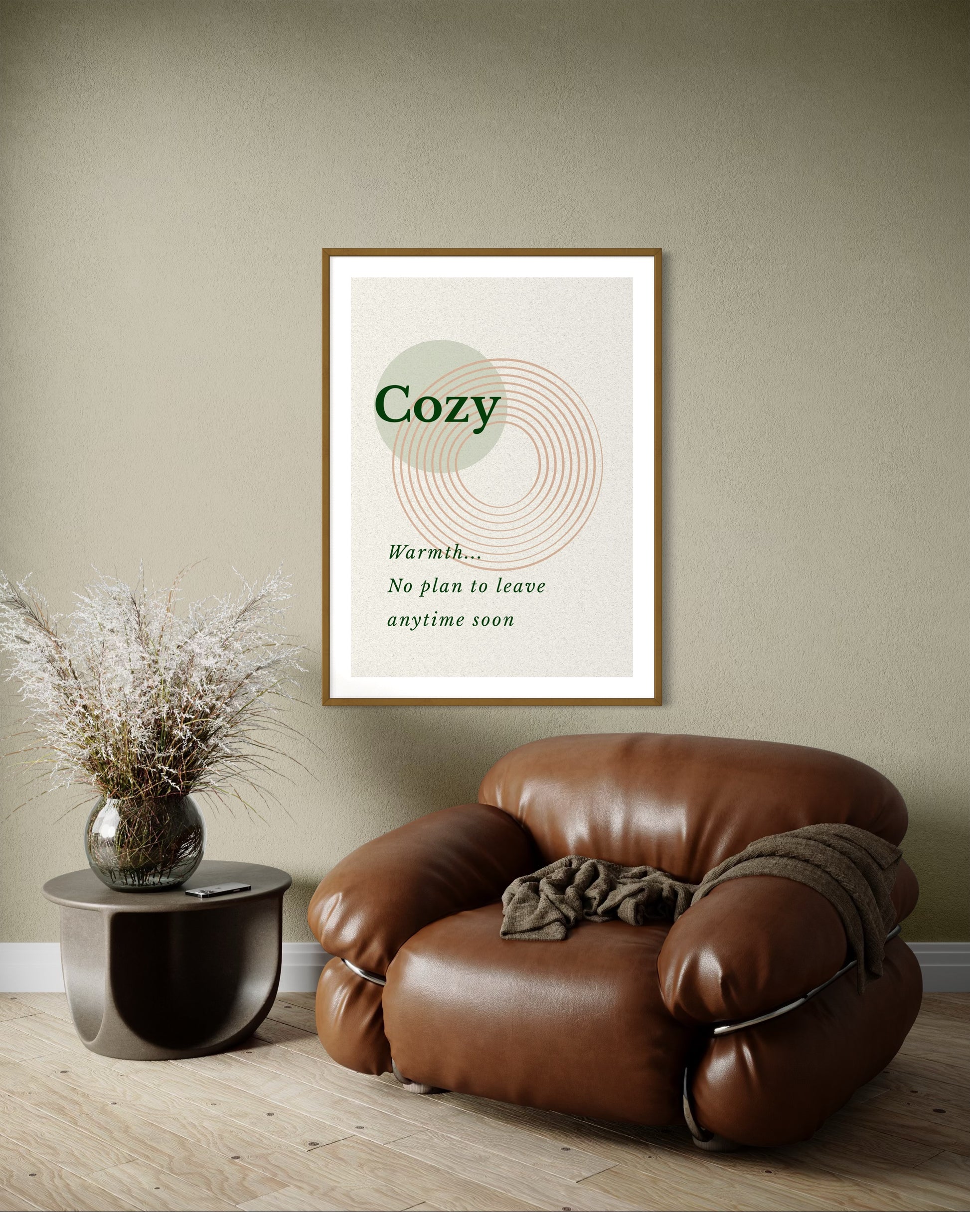 Brown leather armchair in a room with a framed poster on the wall.