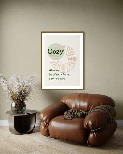 Brown leather armchair in a room with a framed poster on the wall.