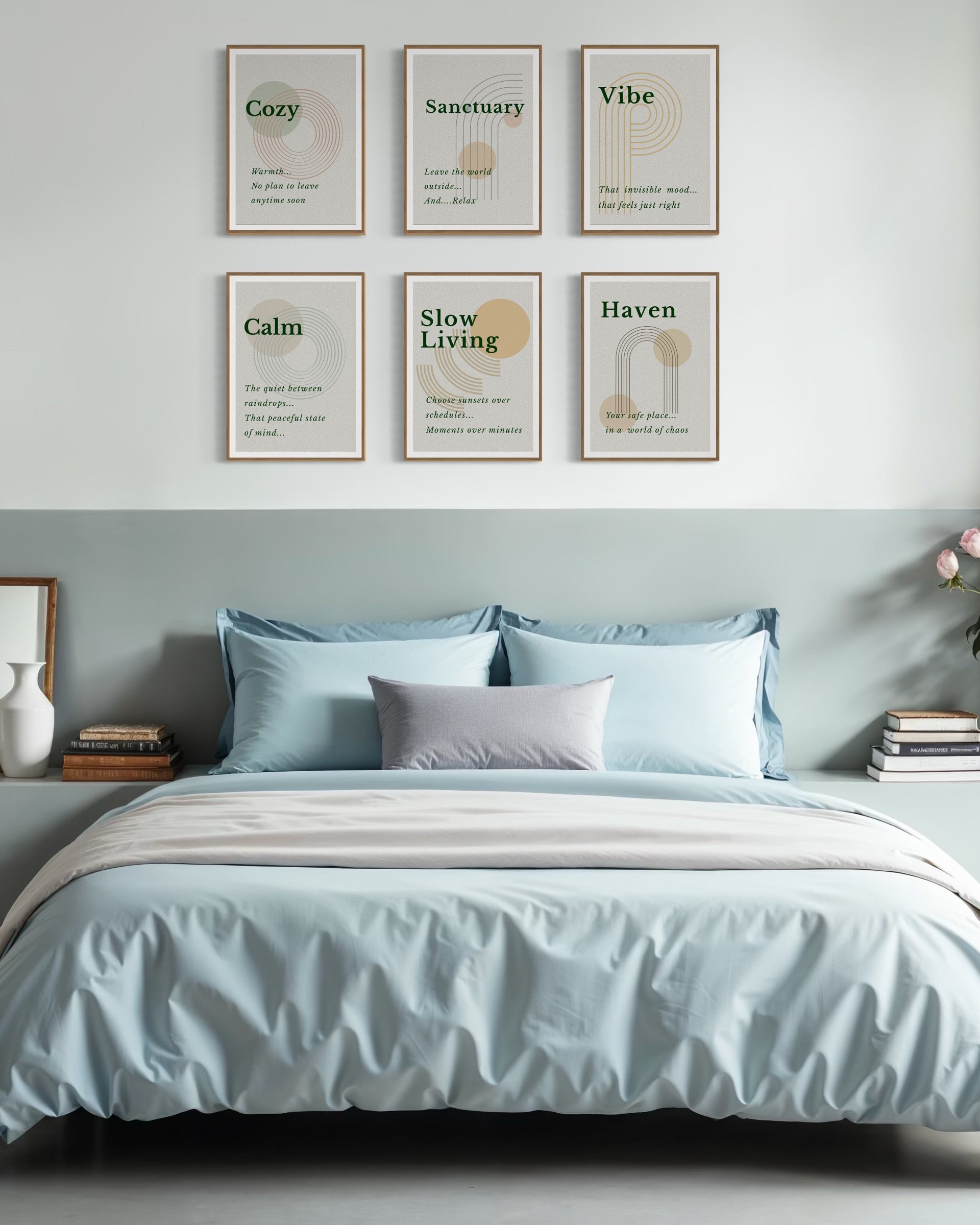 Bedroom with light blue bedding and framed prints on the wall.