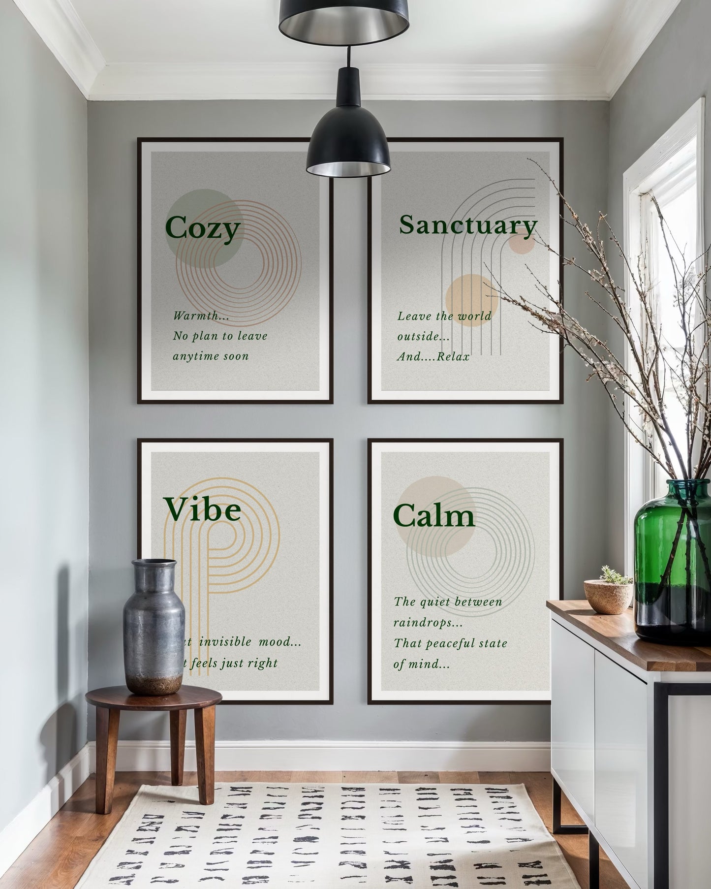 Four framed prints on a wall with motivational phrases in a home setting.