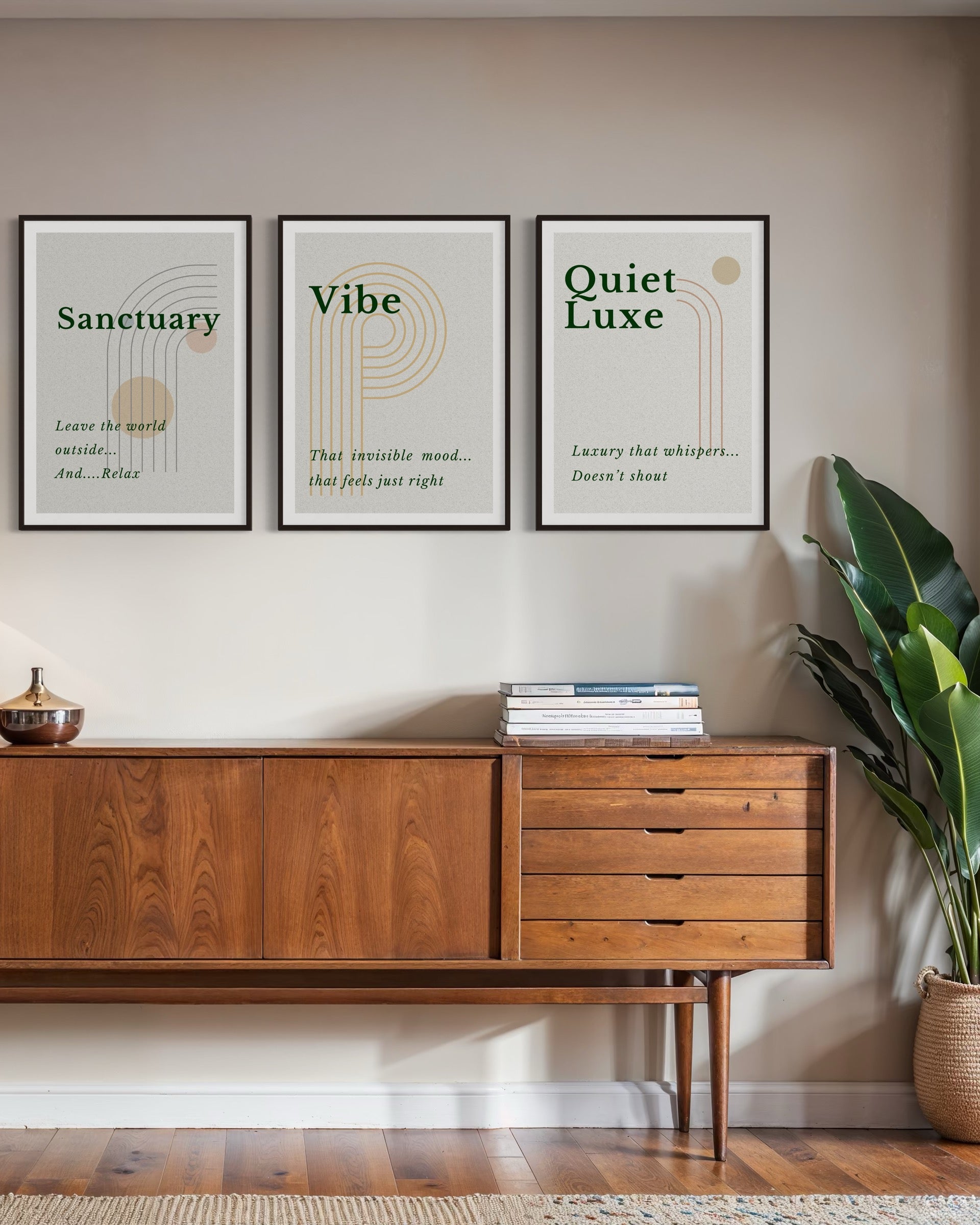 Wooden sideboard with framed prints on a wall, featuring words like 'Sanctuary', 'Vibe', and 'Quiet Luxe'.