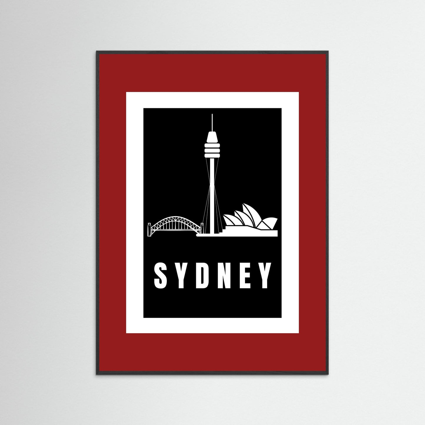 Framed artwork with Sydney skyline silhouette and 'Sydney' text on a black background with a deep red border