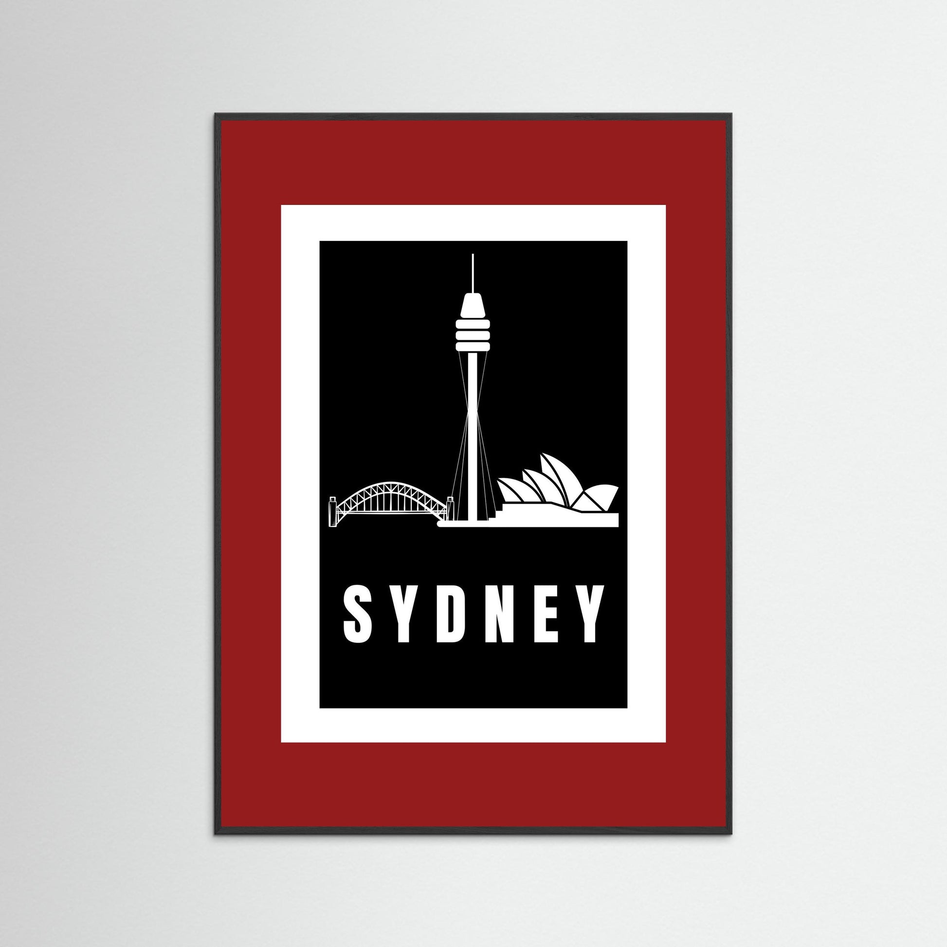 Framed artwork with Sydney skyline silhouette and 'Sydney' text on a black background with a deep red border