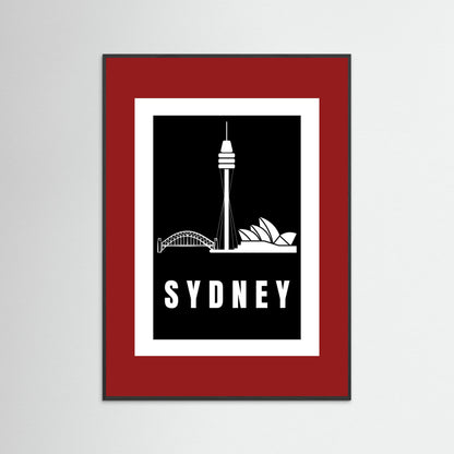 Framed artwork with Sydney skyline silhouette and 'Sydney' text on a black background with a deep red border