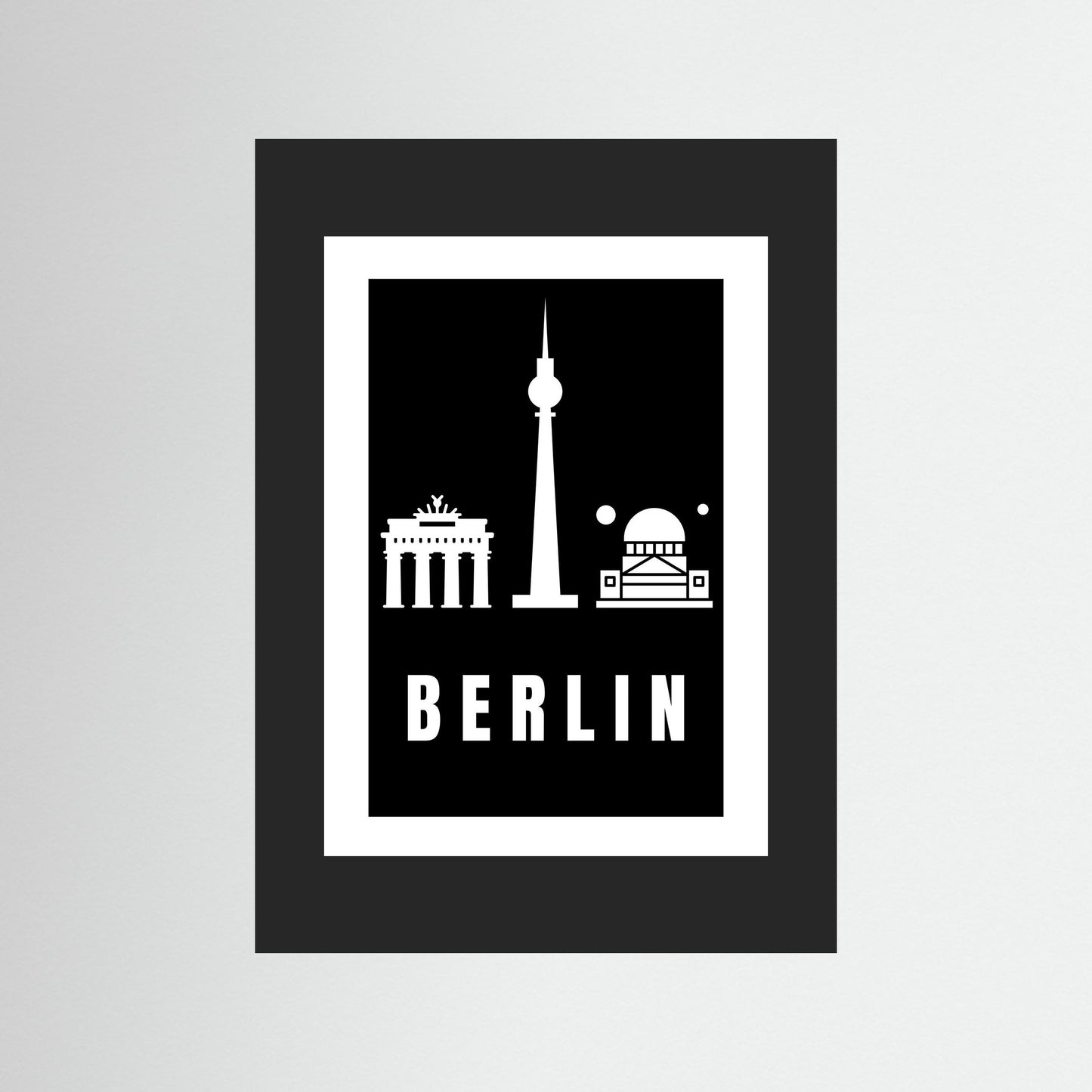 Unframed poster with Berlin landmarks and 'BERLIN' text on a black background and black border