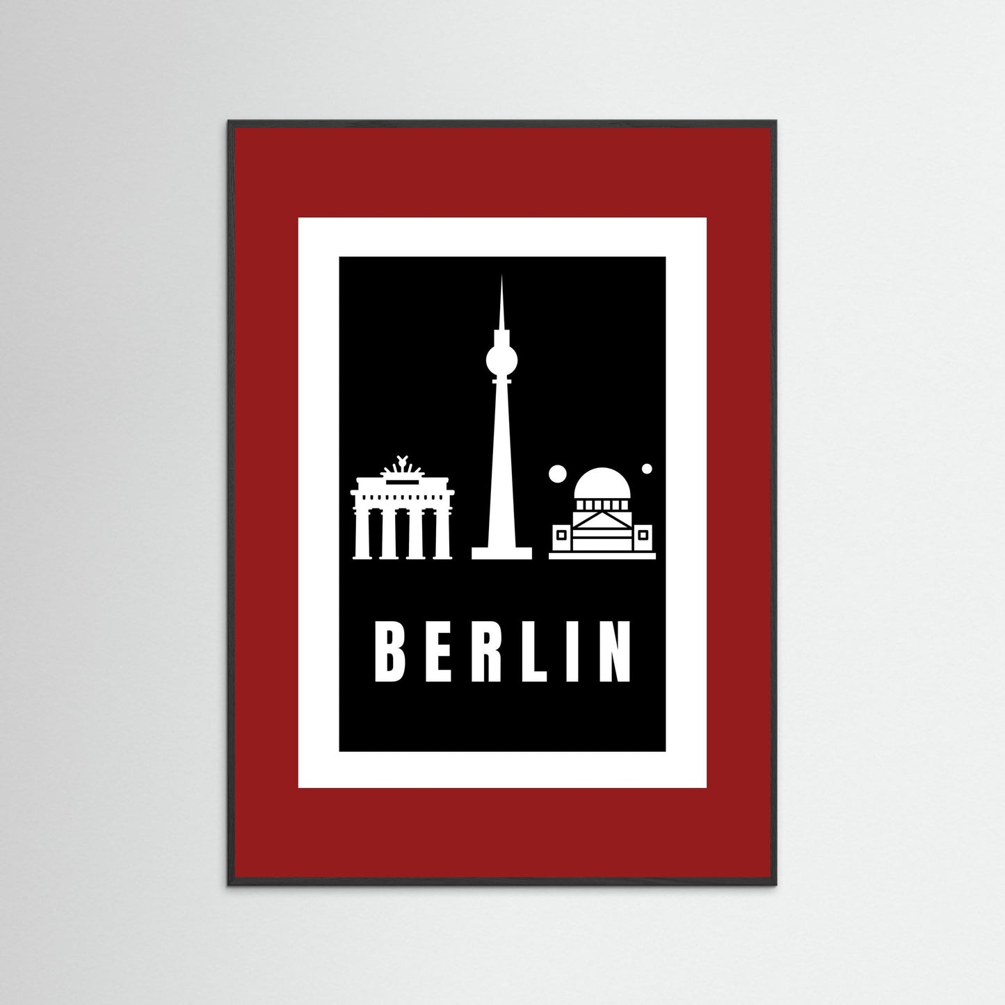 Framed poster with Berlin landmarks on a black background inside a deep red border.