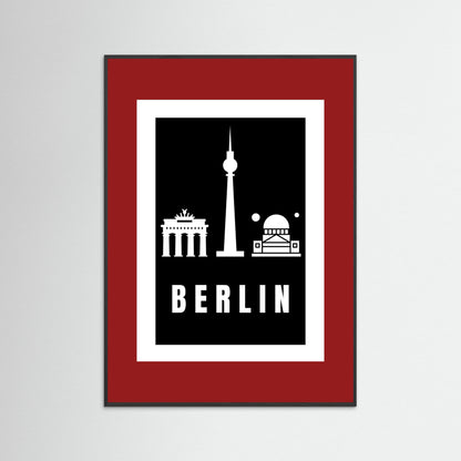 Framed poster with Berlin landmarks on a black background inside a deep red border.