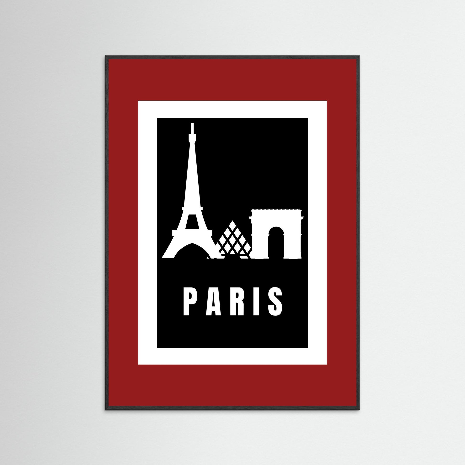 Framed poster with Eiffel Tower and Arc de Triomphe silhouettes on a black background with 'PARIS' text, framed in red.