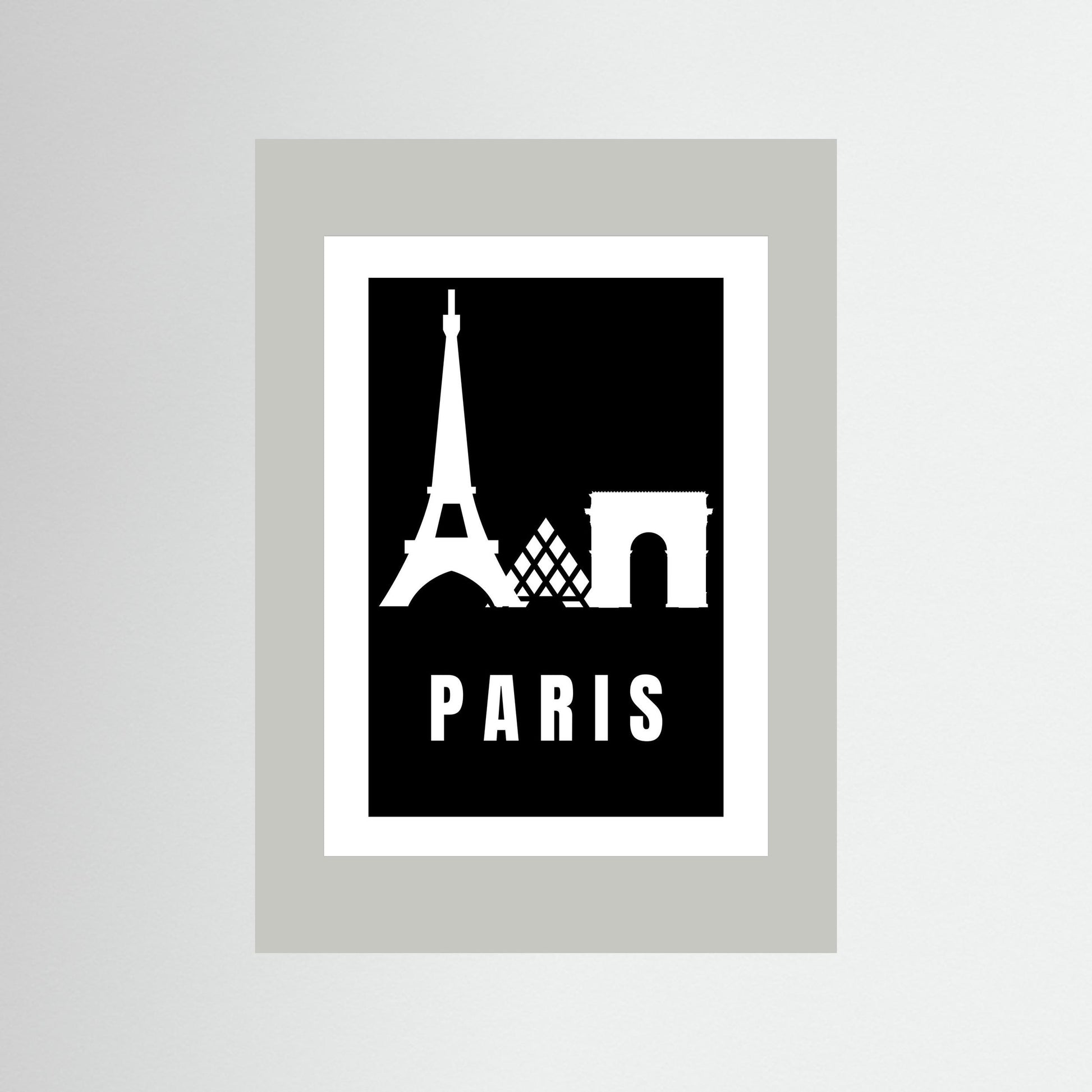 Framed poster with Eiffel Tower and Arc de Triomphe silhouettes on a black background with 'PARIS' text. Framed in light grey